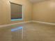 A serene bedroom features glossy tiled floors and a modern window shade at 18104 Sweet Jasmine Dr, Tampa, FL 33647