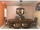 Formal dining room with a large wooden table, ornate chairs, and a decorative chandelier at 18104 Sweet Jasmine Dr, Tampa, FL 33647