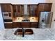 Close-up of a kitchen featuring stainless steel appliances, granite countertops, and custom cabinetry at 18104 Sweet Jasmine Dr, Tampa, FL 33647