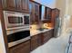 Built-in stainless steel oven and microwave surrounded by custom kitchen cabinetry at 18104 Sweet Jasmine Dr, Tampa, FL 33647