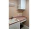 Laundry room features sink, counter space, and cabinet storage at 18104 Sweet Jasmine Dr, Tampa, FL 33647