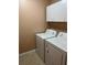 Laundry room with white washer and dryer units and white storage cabinets at 18104 Sweet Jasmine Dr, Tampa, FL 33647