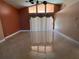 Spacious living room with high ceilings, tiled floors, and bright sliding glass doors at 18104 Sweet Jasmine Dr, Tampa, FL 33647