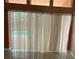 Living room with large windows and blinds with a pool visible outside at 18104 Sweet Jasmine Dr, Tampa, FL 33647