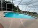 Enjoy this covered pool with clear blue water, surrounded by a patio and lush landscaping for privacy at 18104 Sweet Jasmine Dr, Tampa, FL 33647