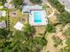 Aerial view of community pool, clubhouse, playground, sand volleyball court, and mature landscaping at 19025 Callaway Ct, Tampa, FL 33647