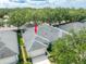 Aerial view of a gray roof home surrounded by lush trees in a well-maintained neighborhood at 19025 Callaway Ct, Tampa, FL 33647