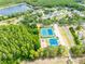 Aerial view of community tennis courts, playground, lake and verdant trees and landscaping at 19025 Callaway Ct, Tampa, FL 33647