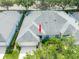 Aerial view of a gray roof home with well-manicured landscaping in a peaceful neighborhood setting at 19025 Callaway Ct, Tampa, FL 33647