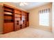 Bedroom features custom built-in shelving and a ceiling fan at 19025 Callaway Ct, Tampa, FL 33647