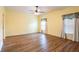Comfortable bedroom featuring wood floors, two windows, and neutral yellow paint at 19025 Callaway Ct, Tampa, FL 33647