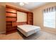 Bedroom featuring a murphy bed, custom shelving and ceiling fan at 19025 Callaway Ct, Tampa, FL 33647