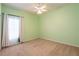 Neutral bedroom with a ceiling fan, neutral carpet, and natural light at 19025 Callaway Ct, Tampa, FL 33647