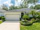 Attractive single-story home with a two-car garage, manicured lawn, and mature landscaping at 19025 Callaway Ct, Tampa, FL 33647