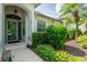 Inviting front porch with a glass door and well-manicured greenery at 19025 Callaway Ct, Tampa, FL 33647
