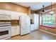 Bright eat-in kitchen featuring white appliances, granite countertops, and a breakfast nook at 19025 Callaway Ct, Tampa, FL 33647