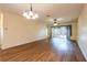 Large living room with wood floors, neutral walls, and sliding glass doors to the lanai at 19025 Callaway Ct, Tampa, FL 33647