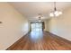 Open-concept living room with hardwood flooring, ceiling fan, and plenty of natural light at 19025 Callaway Ct, Tampa, FL 33647