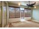 Sunroom features lots of windows, ceiling fan, and door to backyard at 19025 Callaway Ct, Tampa, FL 33647