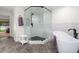Bright, updated bathroom with a glass shower and standalone tub with tile flooring at 1951 Downing Pl, Palm Harbor, FL 34683