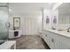 Bright bathroom features a double vanity, large tub, standalone shower, and shuttered windows at 1951 Downing Pl, Palm Harbor, FL 34683