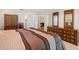 Well-decorated bedroom with an ornate armoire, dresser and french doors to other rooms in the house at 1951 Downing Pl, Palm Harbor, FL 34683