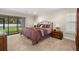 Comfortable bedroom with sliding doors to outdoor space and a decorative wrought iron bed frame at 1951 Downing Pl, Palm Harbor, FL 34683