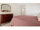Comfortable bedroom with a large closet and antique wooden dresser with a stylish mirror at 1951 Downing Pl, Palm Harbor, FL 34683