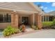 Inviting covered front porch and front door with decorative plants and brick pillars on the walkway at 1951 Downing Pl, Palm Harbor, FL 34683