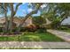Charming single-story home with mature trees and manicured landscaping at 1951 Downing Pl, Palm Harbor, FL 34683