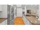 Modern kitchen has granite countertops, stainless steel appliances, and hardwood floors at 1951 Downing Pl, Palm Harbor, FL 34683