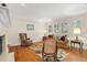 Bright living room with hardwood floors, decorative fireplace, and ample seating for entertaining guests at 1951 Downing Pl, Palm Harbor, FL 34683