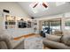 Cozy living room features custom built-ins and shelving, plush seating, and access to screened outdoor space at 1951 Downing Pl, Palm Harbor, FL 34683