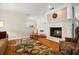 Comfortable living room featuring a stone fireplace, hardwood floors, and plenty of natural light at 1951 Downing Pl, Palm Harbor, FL 34683