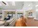 Open-concept living room with hardwood floors connecting to kitchen and bar seating area overlooks pool at 1951 Downing Pl, Palm Harbor, FL 34683