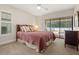 Bedroom with sliding glass door offering view of the pool area at 1951 Downing Pl, Palm Harbor, FL 34683