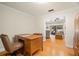 Home office features classic wood desk with view to living room at 1951 Downing Pl, Palm Harbor, FL 34683