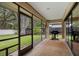 Outdoor grill situated on a screened patio looking out to the backyard at 1951 Downing Pl, Palm Harbor, FL 34683