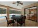 Covered patio with decorative table & chairs beside a screened pool with interior dining area at 1951 Downing Pl, Palm Harbor, FL 34683