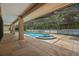 The Kidney-shaped pool and spa are in a large screened enclosure and stone patio at 1951 Downing Pl, Palm Harbor, FL 34683