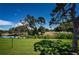 Lush backyard with golf course view, mature trees, and serene pond at 2117 Lakewood Club S Dr # 7K, St Petersburg, FL 33712