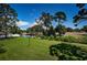 Expansive backyard view featuring lush green grass and a small water feature at 2117 Lakewood Club S Dr # 7K, St Petersburg, FL 33712