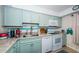 Cozy kitchen features delightful blue cabinetry, modern appliances, and a functional layout at 2117 Lakewood Club S Dr # 7K, St Petersburg, FL 33712