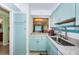 Inviting kitchen features charming blue cabinetry, granite countertops, and a seamless connection to the adjacent living area at 2117 Lakewood Club S Dr # 7K, St Petersburg, FL 33712