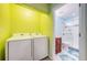 Bright laundry room with a washer and dryer, leading to the bathroom with a walk-in shower at 2117 Lakewood Club S Dr # 7K, St Petersburg, FL 33712