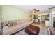 Spacious living room with sofa, ottoman, ceiling fan, and dining area, creating a welcoming atmosphere at 2117 Lakewood Club S Dr # 7K, St Petersburg, FL 33712