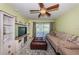 Bright living room with ceiling fan, modern media center, and large couch for relaxing and entertaining at 2117 Lakewood Club S Dr # 7K, St Petersburg, FL 33712