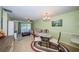 This living room features a dining area and offers access to outdoor views from the sliding glass door at 2117 Lakewood Club S Dr # 7K, St Petersburg, FL 33712