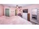 Comfortable bedroom featuring a TV, sitting area, and ensuite bathroom access at 2117 Lakewood Club S Dr # 7K, St Petersburg, FL 33712