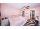 Relaxing bedroom with pink walls, tiled floors, and access to ensuite bathroom at 2117 Lakewood Club S Dr # 7K, St Petersburg, FL 33712